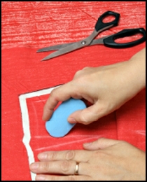 Hands marking fabric pattern